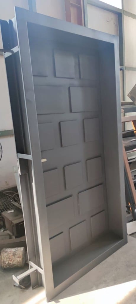Pressed steel panel door leaf standing in the plant after finishing